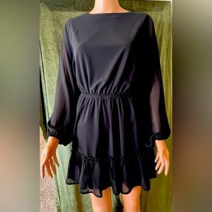 Black mid thigh length chiffon dress.